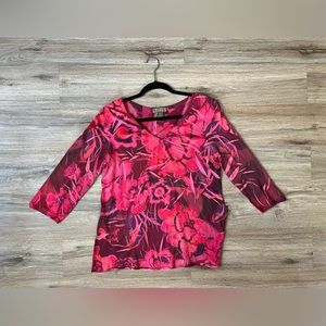 Size is a Small. Floral design. Pink shirt.